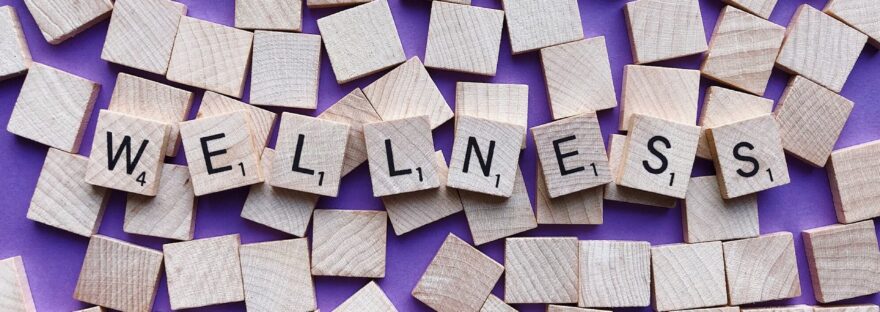 Scrabble tiles with wellness written on them