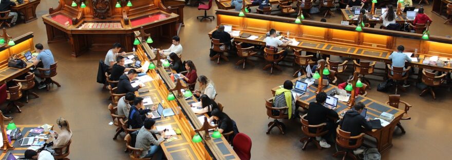 Students in a library, studying at desks
